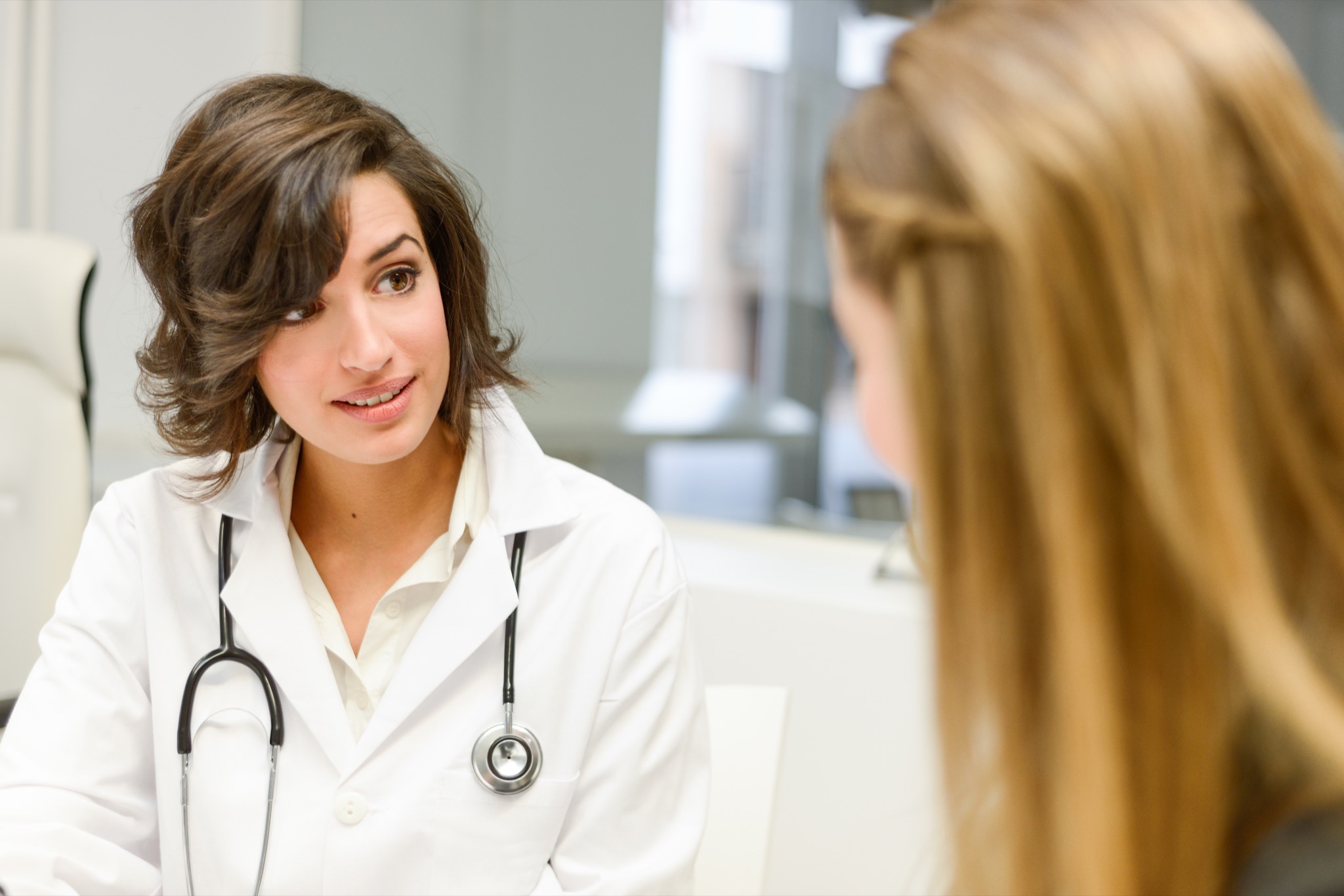 Surgeon discussing breast cancer surgery options with a patient during a consultation